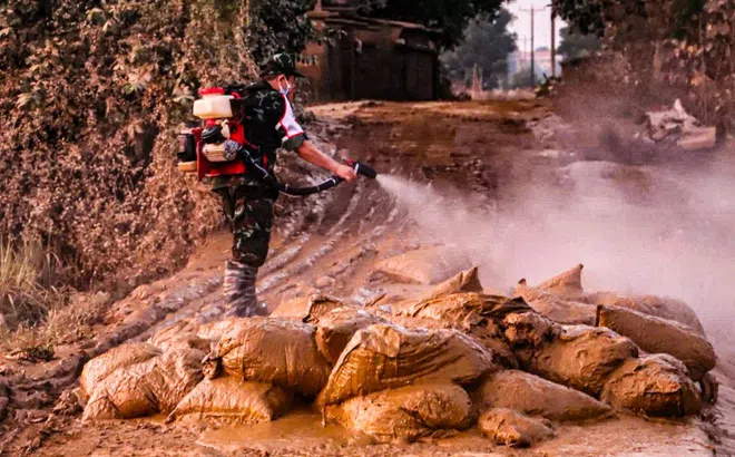 Quân y đến từng nhà, từng lớp học phun khử khuẩn, khám bệnh cho người dân vùng lũ